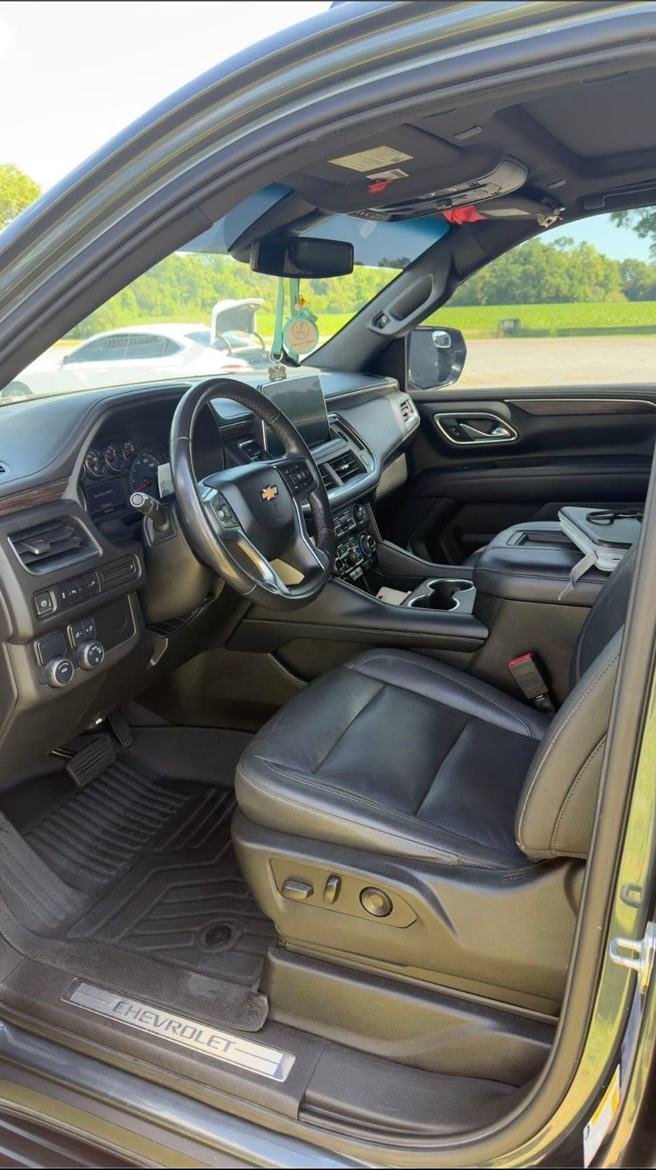 Driver-side leather interior of a Chevrolet Tahoe cleaned by ShineCraft mobile detailing in Olathe.